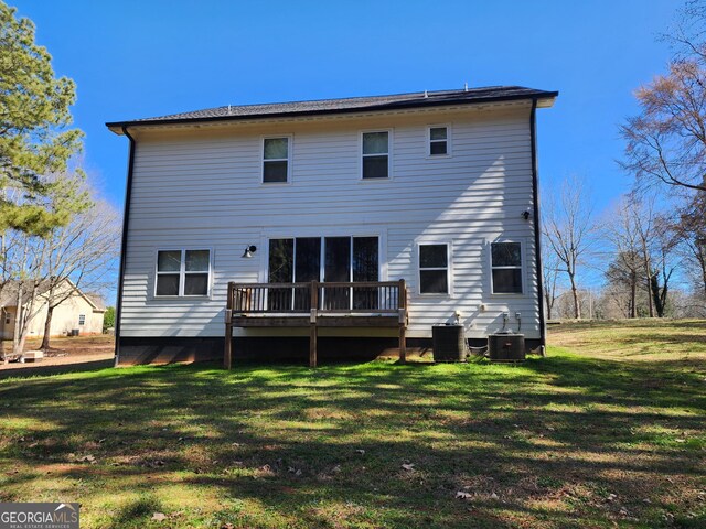 back of property featuring a yard, a deck, and central AC unit