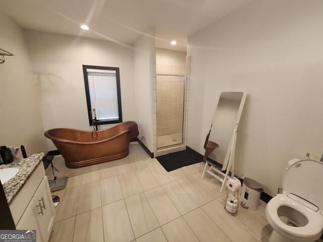 bathroom with a freestanding tub, recessed lighting, vanity, baseboards, and a shower stall