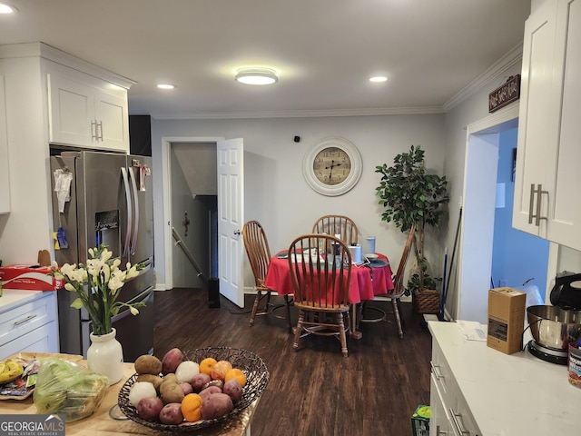 dining area featuring crown molding and dark hardwood / wood-style flooring