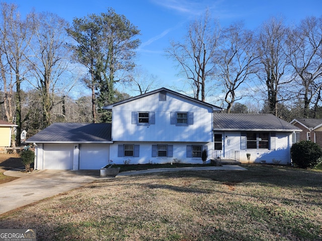 tri-level home featuring a garage and a front lawn