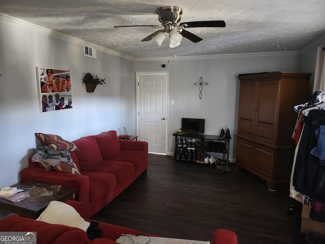 living room featuring a textured ceiling, wood finished floors, visible vents, and crown molding