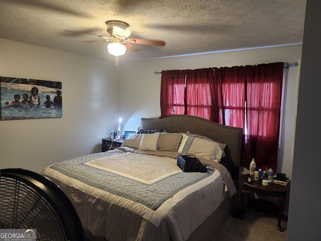 carpeted bedroom featuring ceiling fan and a textured ceiling