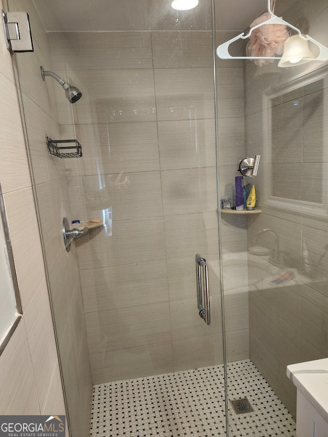 bathroom featuring a shower with shower door