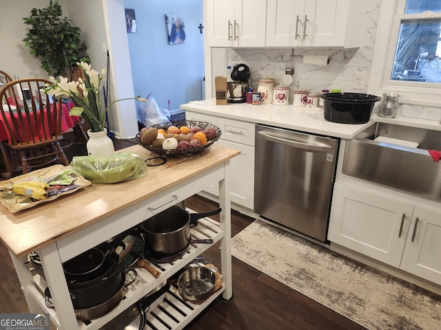 kitchen with white cabinetry, dishwasher, dark wood-type flooring, and tasteful backsplash