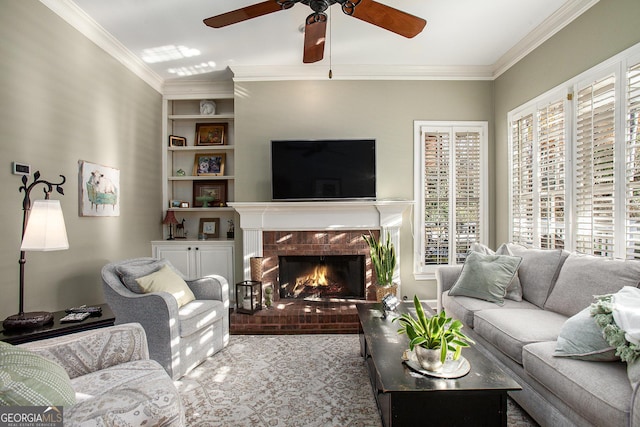 living room with a fireplace, ceiling fan, ornamental molding, and a healthy amount of sunlight