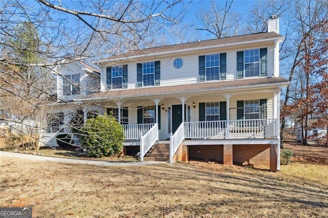 view of front of home featuring covered porch and a front lawn