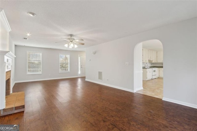 unfurnished living room featuring a fireplace, ceiling fan, and hardwood / wood-style flooring