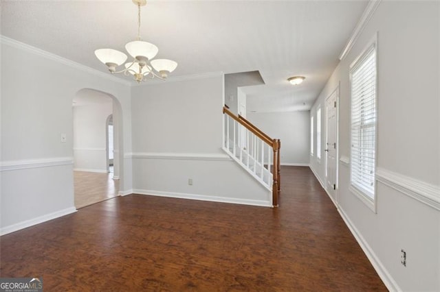 unfurnished room with a chandelier, crown molding, and dark hardwood / wood-style floors