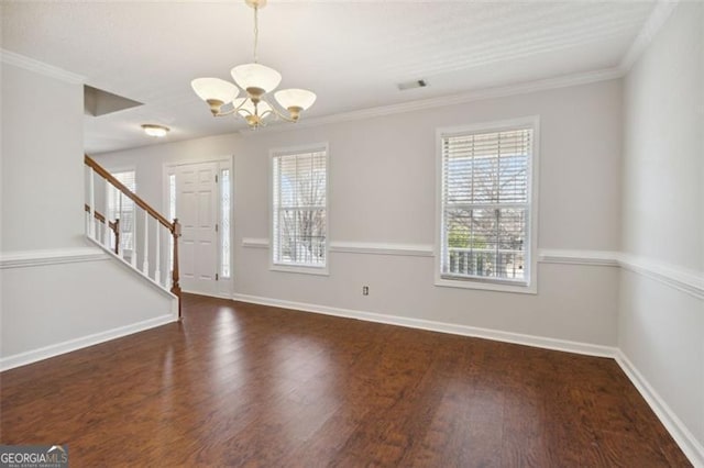 interior space with ornamental molding, dark wood-type flooring, and a notable chandelier