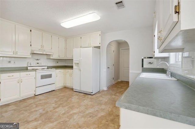 kitchen with sink, white appliances, decorative backsplash, and white cabinets