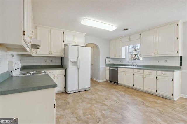 kitchen featuring white appliances, white cabinets, decorative backsplash, and sink