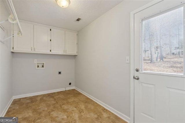 washroom featuring washer hookup, cabinets, a textured ceiling, and electric dryer hookup