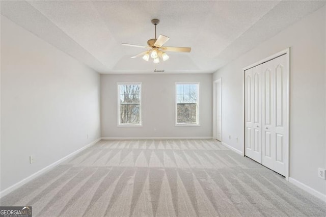 carpeted spare room with a textured ceiling and ceiling fan