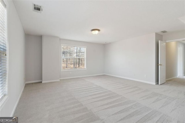 empty room featuring light colored carpet