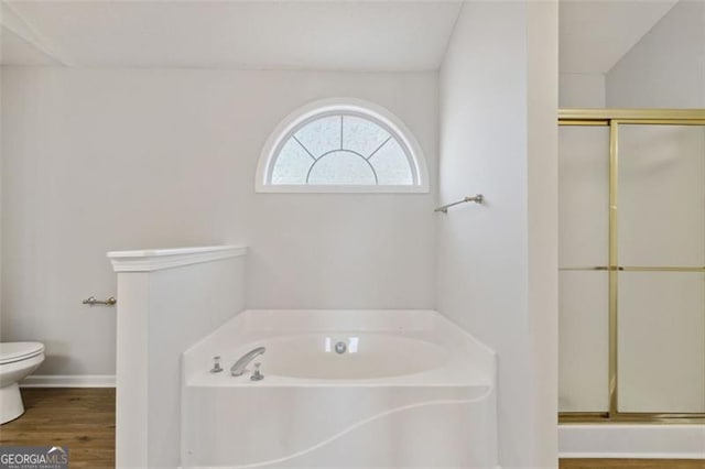 bathroom with toilet, separate shower and tub, and wood-type flooring