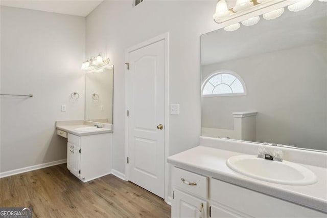 bathroom with hardwood / wood-style floors and vanity