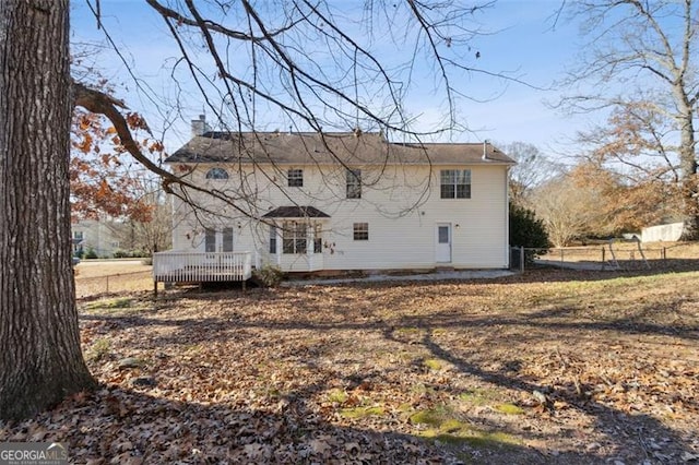 back of property featuring a wooden deck