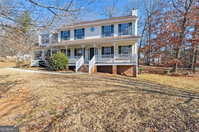 colonial home featuring a front yard and covered porch