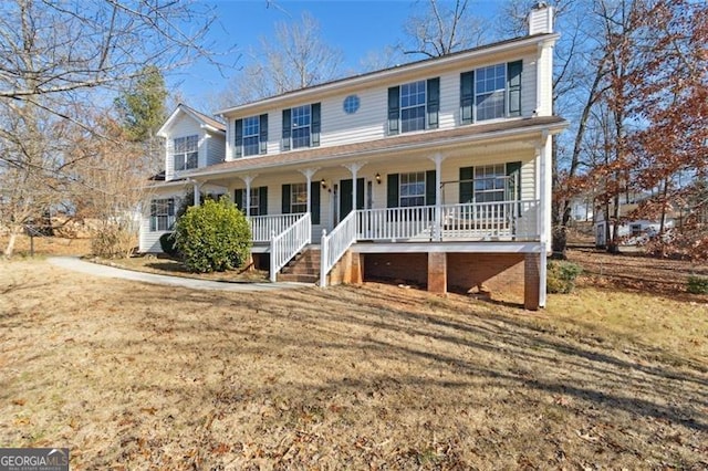 view of front of home with a porch and a front yard