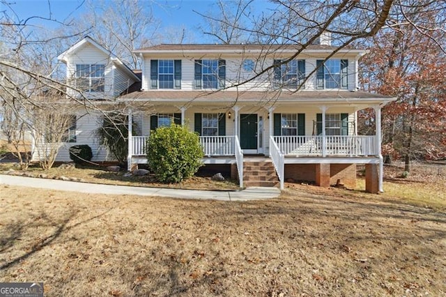 view of front facade featuring covered porch and a front yard