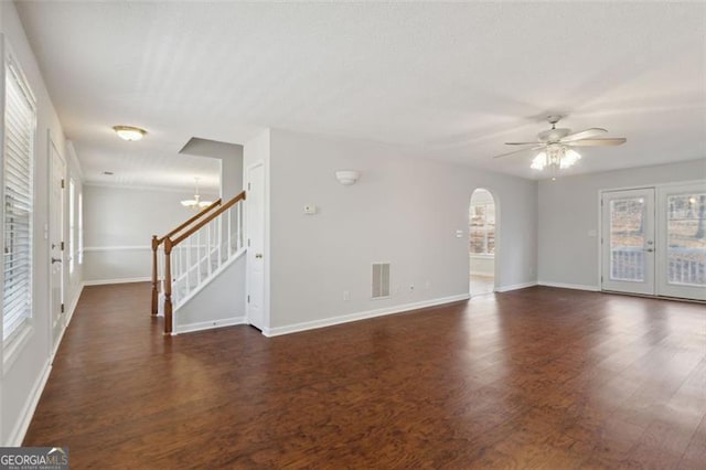 unfurnished room featuring french doors, dark hardwood / wood-style floors, and ceiling fan with notable chandelier