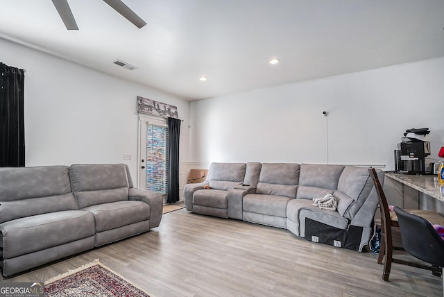 living room featuring ceiling fan and light hardwood / wood-style flooring