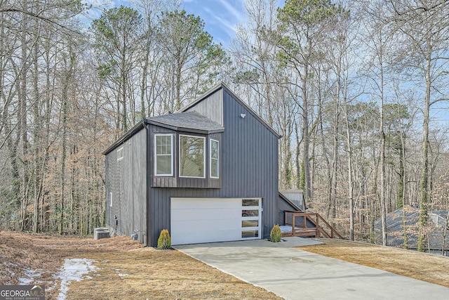 exterior space with a garage and central AC unit