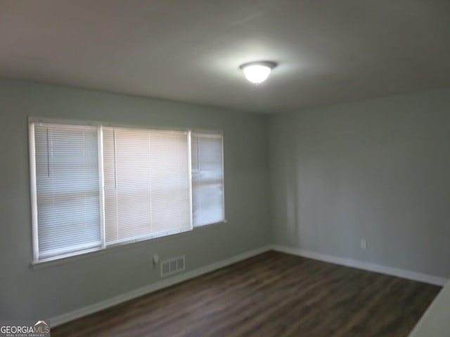 unfurnished room with dark hardwood / wood-style floors