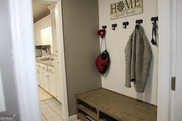 mudroom featuring light tile patterned floors and sink