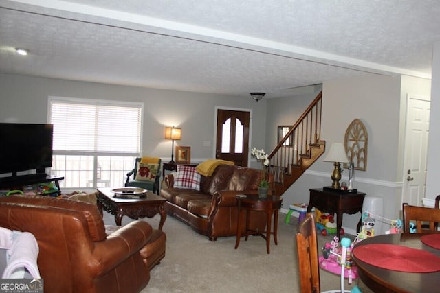 carpeted living room featuring a textured ceiling