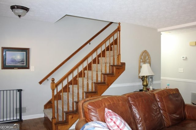 stairs featuring parquet flooring and a textured ceiling