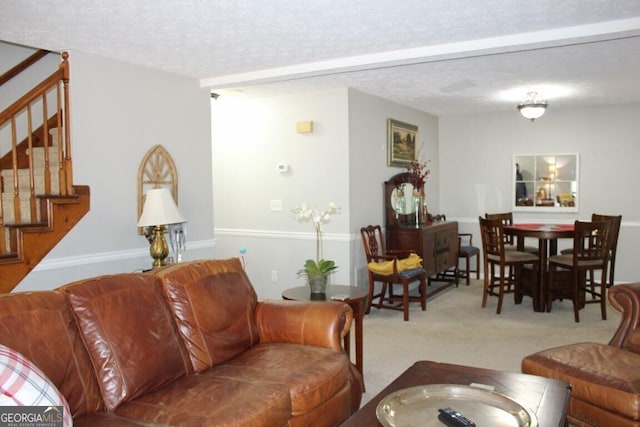 living room featuring light colored carpet and a textured ceiling