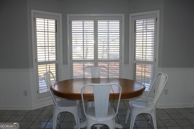 dining room with a wealth of natural light and tile patterned floors