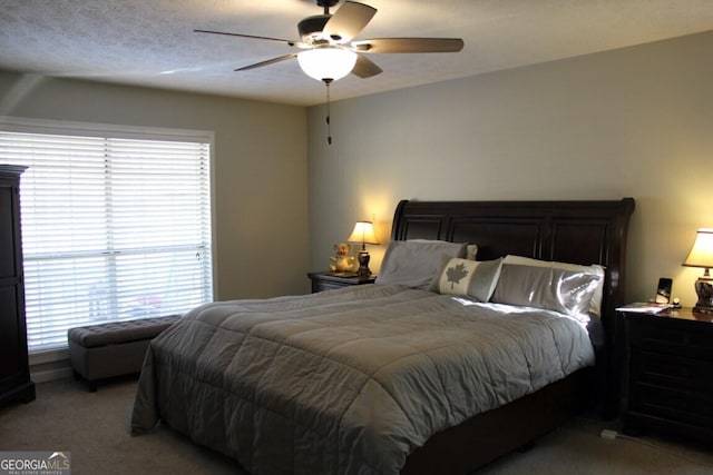 bedroom featuring ceiling fan, light colored carpet, and multiple windows