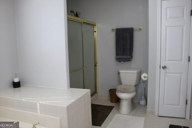 bathroom featuring toilet, walk in shower, and tile patterned flooring