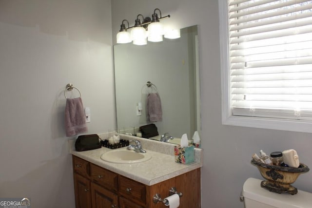 bathroom with toilet and vanity