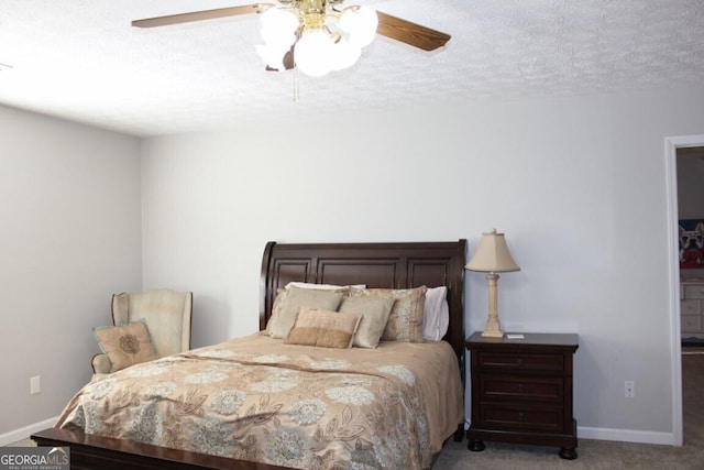 bedroom with ceiling fan, light colored carpet, and a textured ceiling