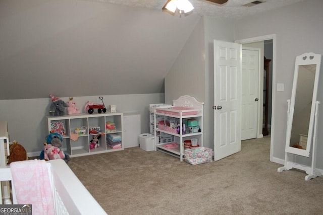 recreation room with carpet, ceiling fan, and vaulted ceiling