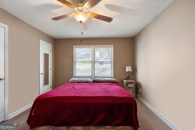 carpeted bedroom featuring a textured ceiling and ceiling fan