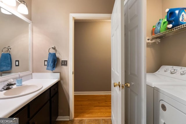 laundry area with independent washer and dryer and sink