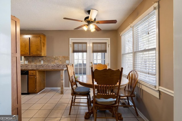 dining space with a textured ceiling, french doors, ceiling fan, and light tile patterned floors