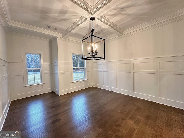 empty room with coffered ceiling, crown molding, beamed ceiling, a notable chandelier, and dark hardwood / wood-style flooring