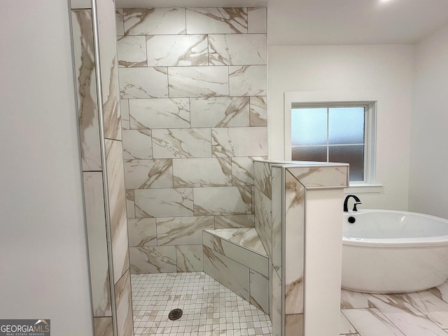 bathroom featuring shower with separate bathtub