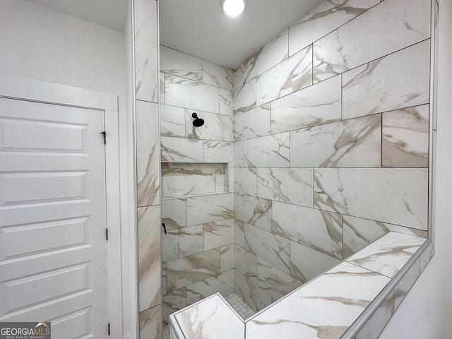 bathroom with tiled shower