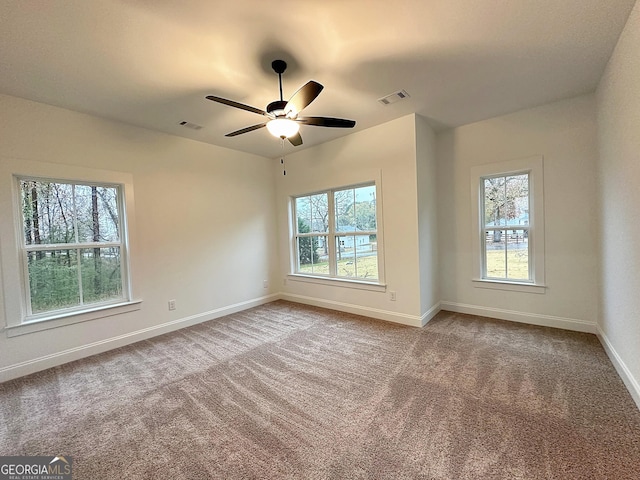 empty room with carpet flooring and ceiling fan