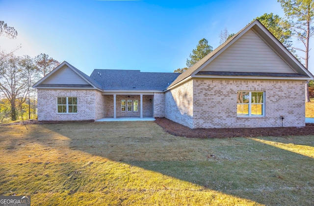 view of front of house with a patio area and a front lawn