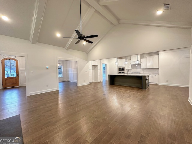 unfurnished living room featuring dark wood-type flooring, high vaulted ceiling, ceiling fan, and beamed ceiling