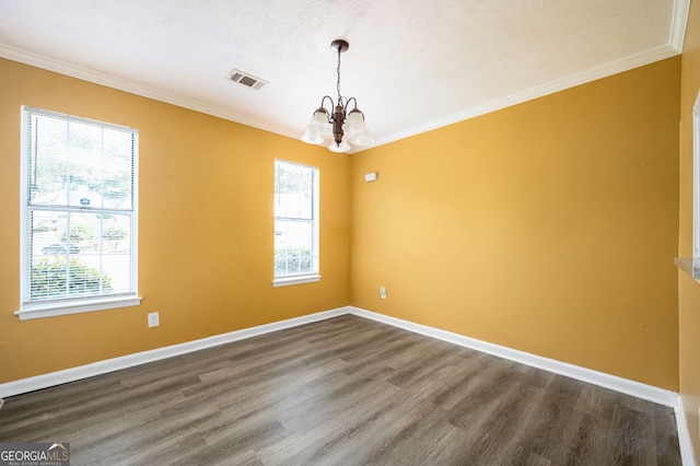 unfurnished room with a textured ceiling, an inviting chandelier, ornamental molding, and hardwood / wood-style flooring