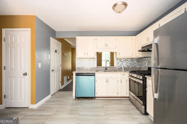 kitchen with sink, stainless steel appliances, light stone counters, and tasteful backsplash