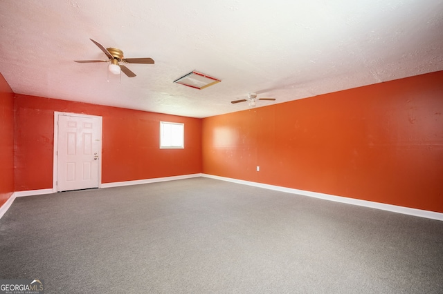 spare room featuring a textured ceiling, ceiling fan, and carpet